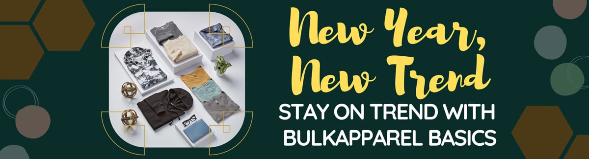Banner for Neatly arranged clothing items in various colors and styles inside a square frame on a green background with text New Year, New Trends - Stay on Trend with BulkApparel Basics