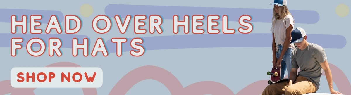 Banner for A standing female skater and a sitting male skater wearing trucker caps with text Head Over Heels For Hats